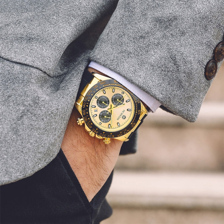 Gold-tone quartz wristwatch on wrist with black silicone strap, multi-dial cream face
