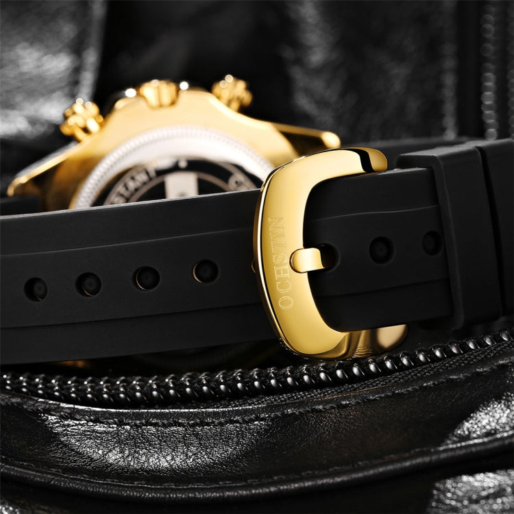 Black silicone watch band with gold-tone caseback and side buttons, close-up