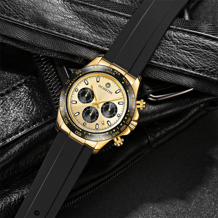 Gold-tone quartz chronograph watch on black strap, white dial with three subdials