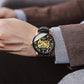 Ochstin mechanical watch on wrist with black leather strap and open skeleton dial