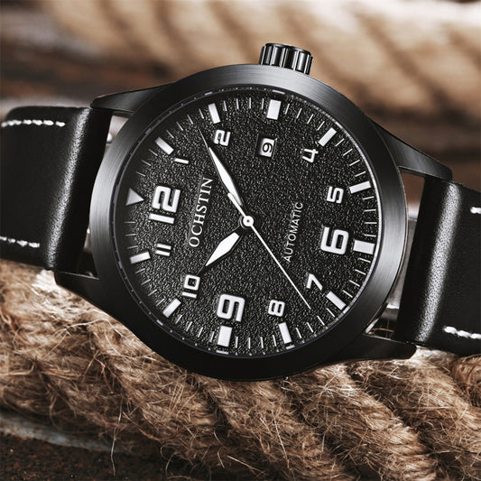Men’s automatic mechanical watch with black dial and black leather strap, angled view.