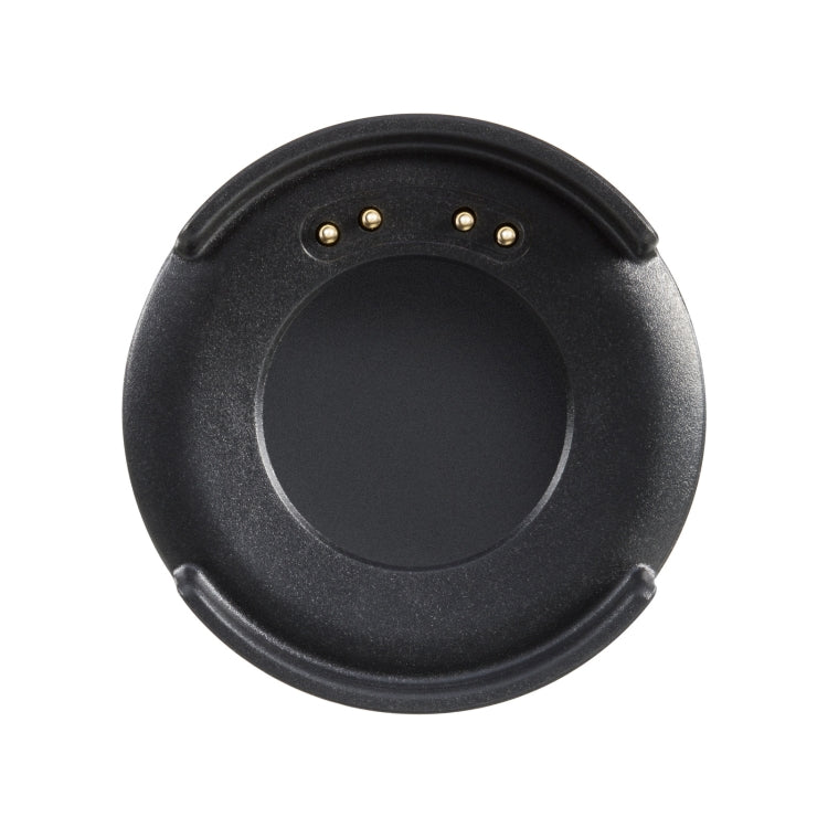 Round black watch charging dock with gold contact pins