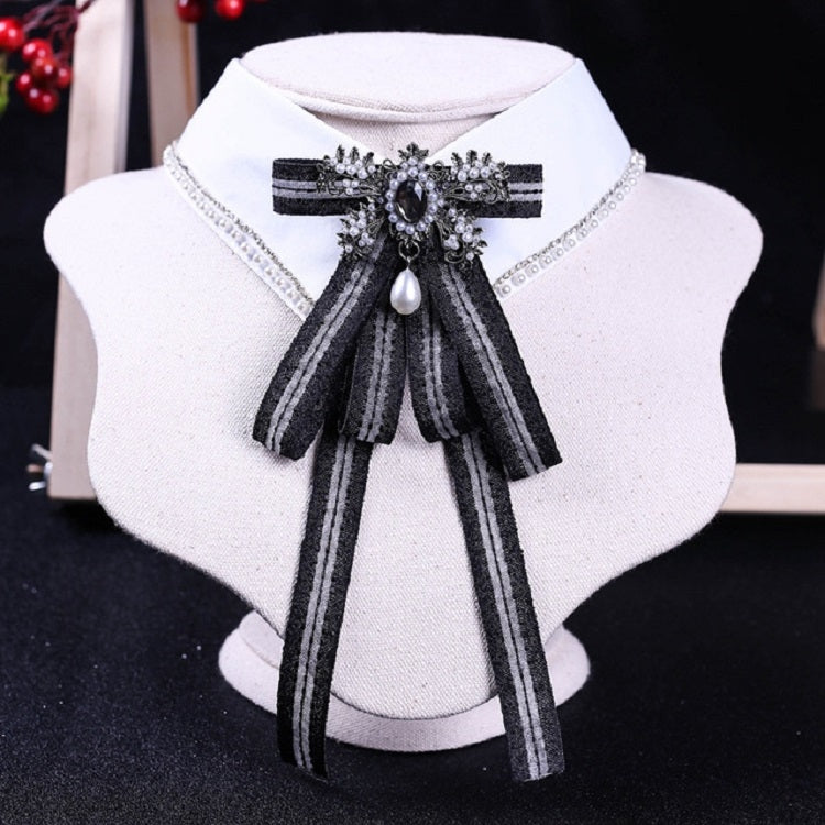White shirt collar with black striped bow tie and rhinestone pearl centerpiece