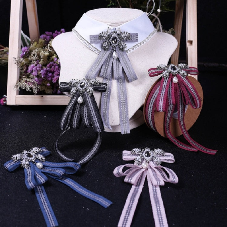White shirt collar with gray striped bow tie; matching blue and purple bows nearby