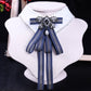 White shirt collar with blue striped bow tie and rhinestone pearl centerpiece