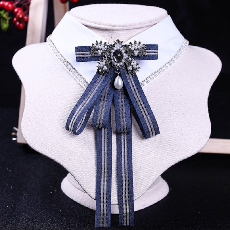 White shirt collar with blue striped bow tie and rhinestone pearl centerpiece