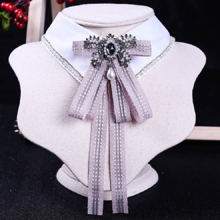 White shirt collar with lilac striped bow tie and rhinestone pearl centerpiece