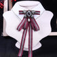 White shirt collar with dark red striped bow tie and rhinestone pearl centerpiece