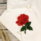 Red rose embroidery patch with green leaves on white fabric