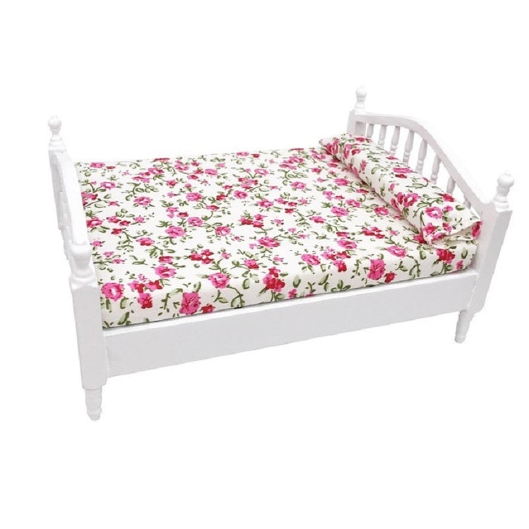 White mini doll bed with floral mattress bedding and raised side rails