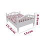 White mini doll bed with floral mattress, 12cm x 15.8cm overall size