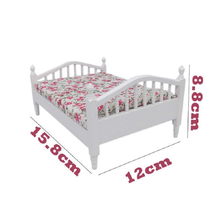White mini doll bed with floral mattress, 12cm x 15.8cm overall size