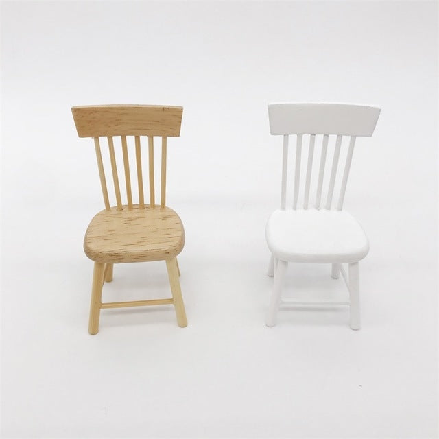 Miniature dining chairs in wood and white, slatted backs and rounded seats.