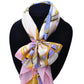 Patterned scarf tied at neck, held with crystal heart buckle brooch