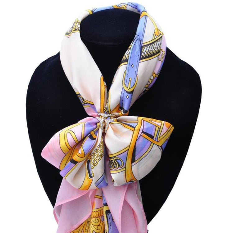 Patterned scarf tied at neck, held with crystal heart buckle brooch