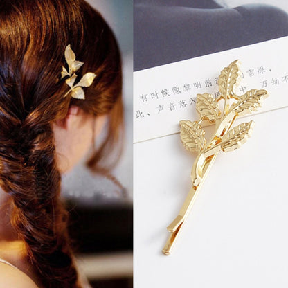 Gold five-leaf hair clip with leaf-shaped metal prongs