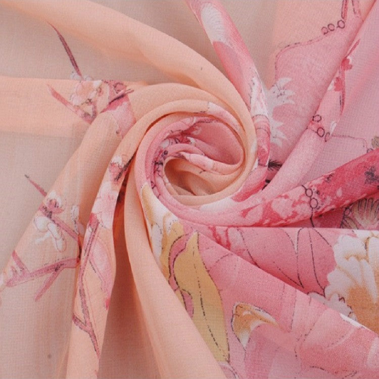 Peach pink chiffon scarf closeup with botanical floral pattern, lightweight sheer