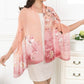 Peach pink floral chiffon scarf shawl draped over shoulders on model