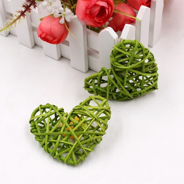 Green rattan heart ornaments, two woven straw hearts with crisscross lattice.