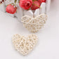 White rattan heart ornaments, two woven straw hearts with crisscross lattice.