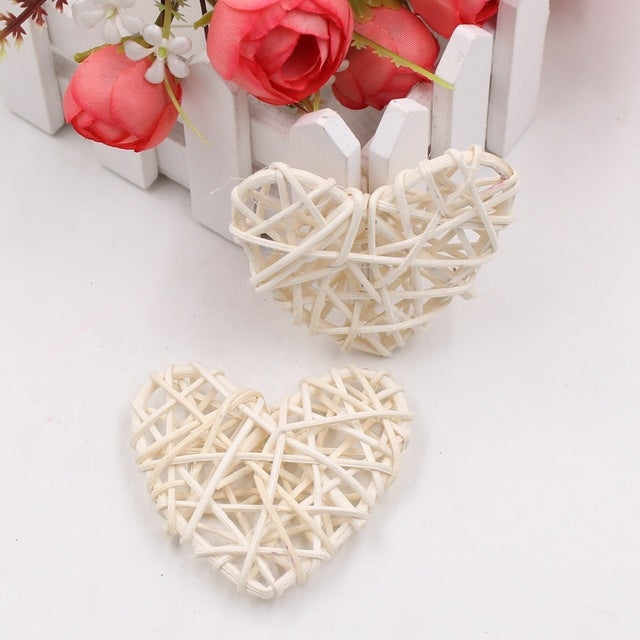 White rattan heart ornaments, two woven straw hearts with crisscross lattice.