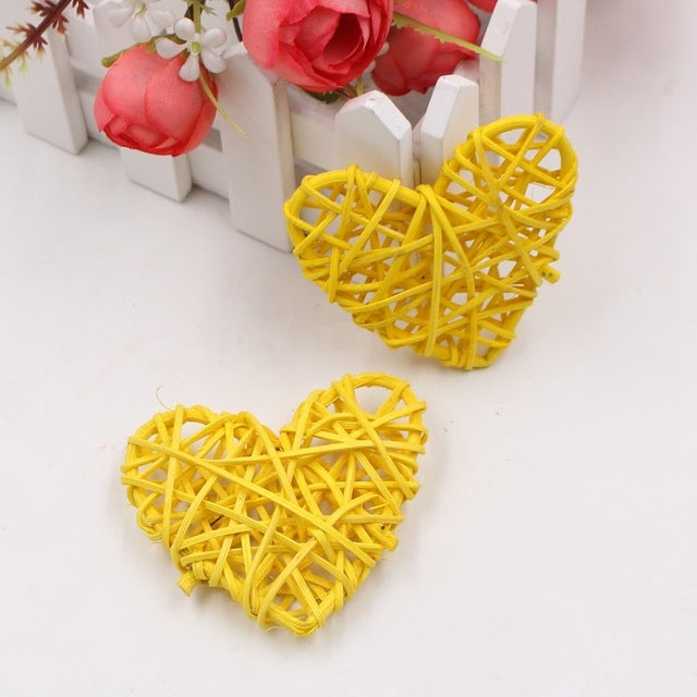Yellow rattan heart ornaments, two woven straw hearts with crisscross lattice.