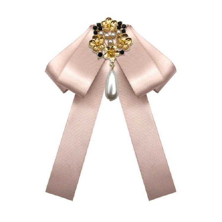 Champagne satin bow brooch with gold and pearl cross centerpiece