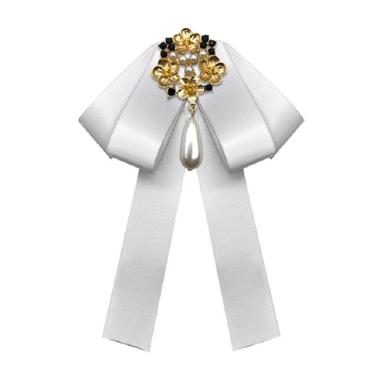 White ribbon bow brooch with gold pearl cross and teardrop pendant