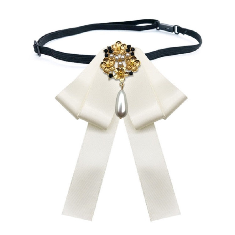 White ribbon bow tie belt with gold and pearl cross centerpiece