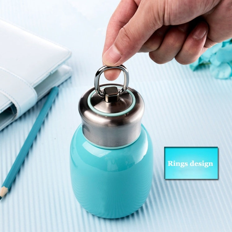 Mini vacuum flask with turquoise body and stainless ring handle on the screw-top lid.