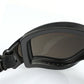 Close-up of black UV goggles lens with tinted glass and side mounting frame.