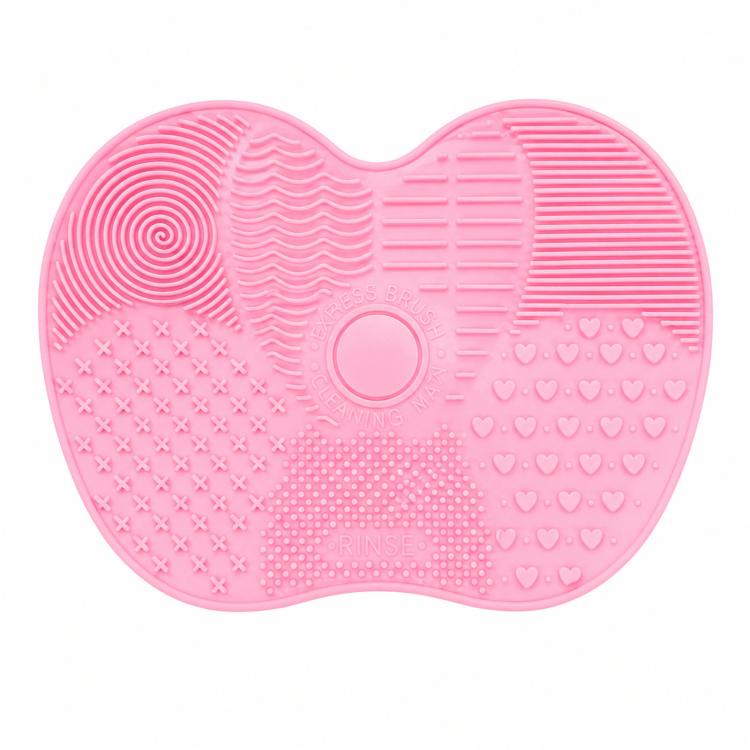 Pink silicone heart-shaped brush cleaner mat close-up with spiral and heart textures