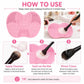 Pink silicone heart brush cleaning mat shown with makeup brush swirling and rinsing