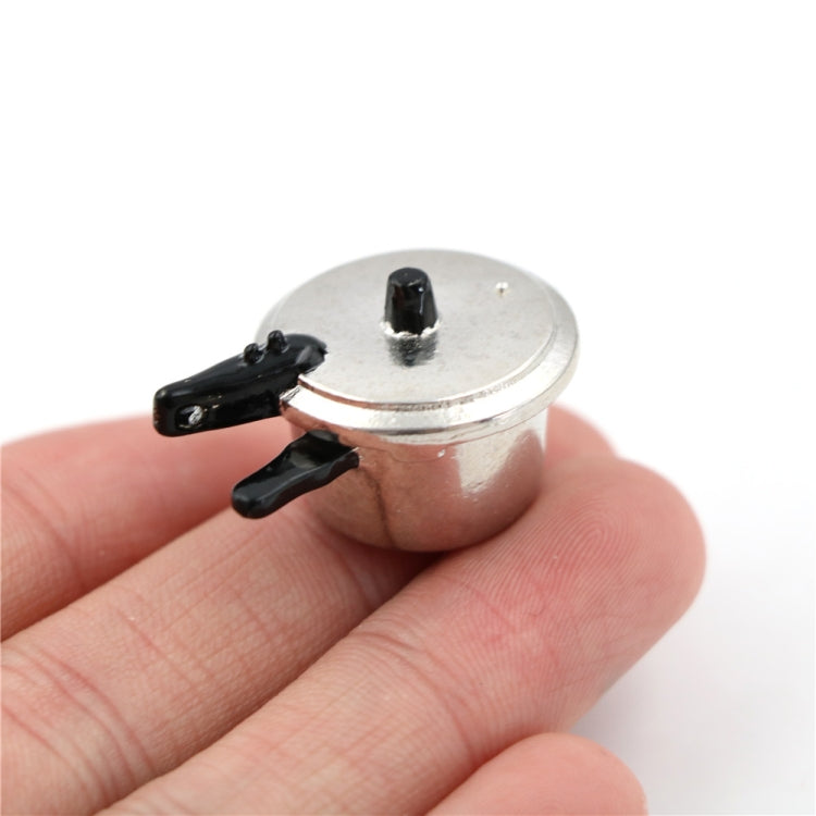Mini metal pressure cooker toy with lid and black handle accents