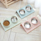 Multiple slope pet bowl stands with stainless inserts in mint, light blue, and pink