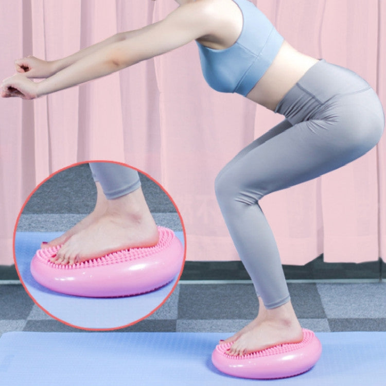 Pink massage balance cushion with raised nubs for yoga, under bare feet