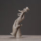Abstract light-gray sculpted hands reaching upward with a small rose on top.