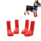 Dog wearing red waterproof rain boots with a set of four matching boots