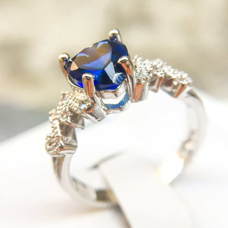 Sterling silver ring with blue heart-cut center stone and small pave accents