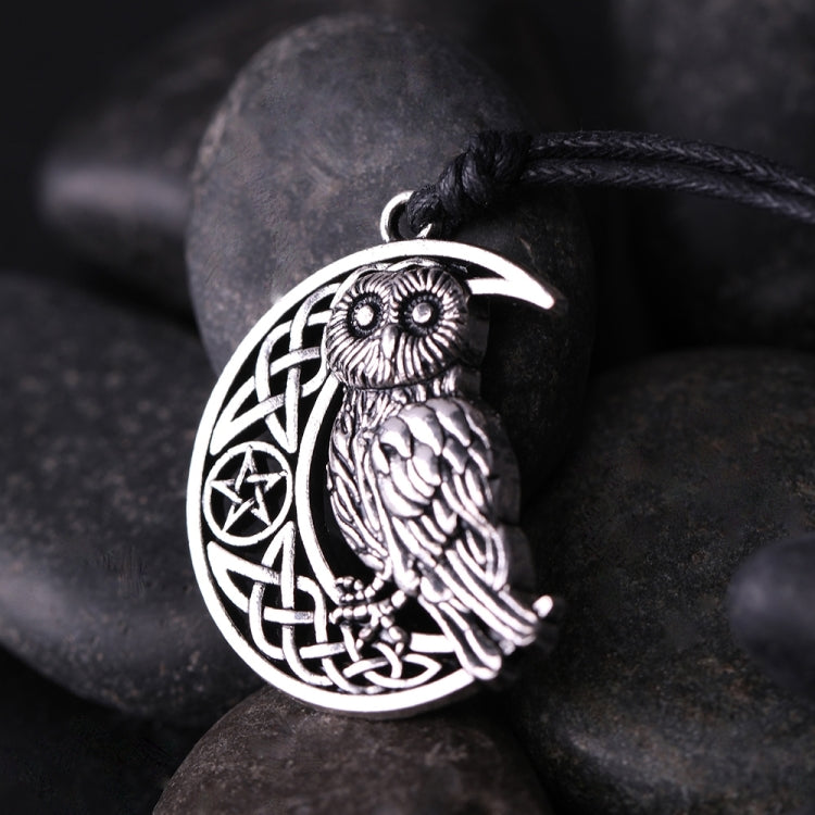 Antique silver owl moon pendant close-up with celtic knot and detailed feathers