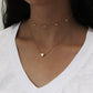 Gold multi-layer heart clavicle necklace worn on neckline with two hearts
