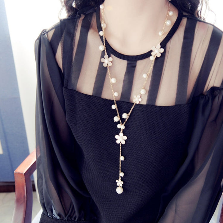 Long pearl necklace with five-petal flower charms and center dangling pearl strand
