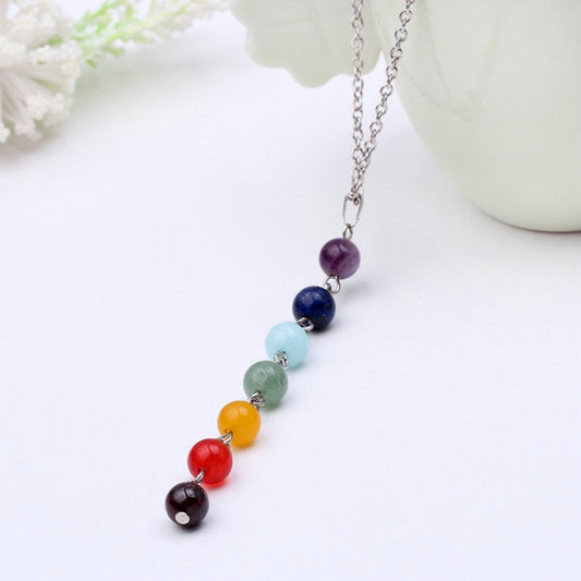 Beaded pendant necklace featuring purple, navy, light blue, green, yellow, red, dark round stones