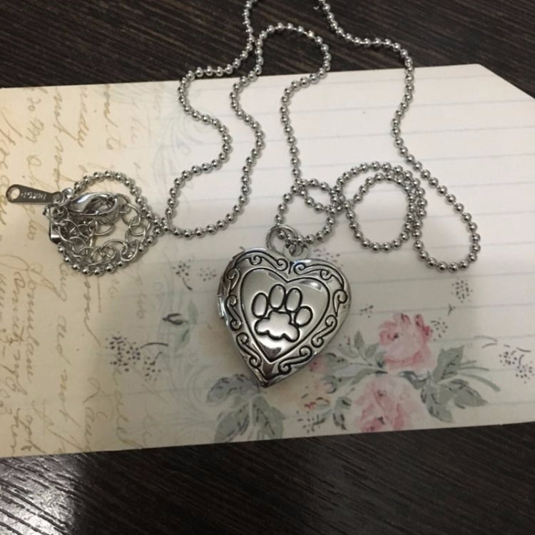 Silver-tone heart locket pendant necklace with ball chain and paw-print front