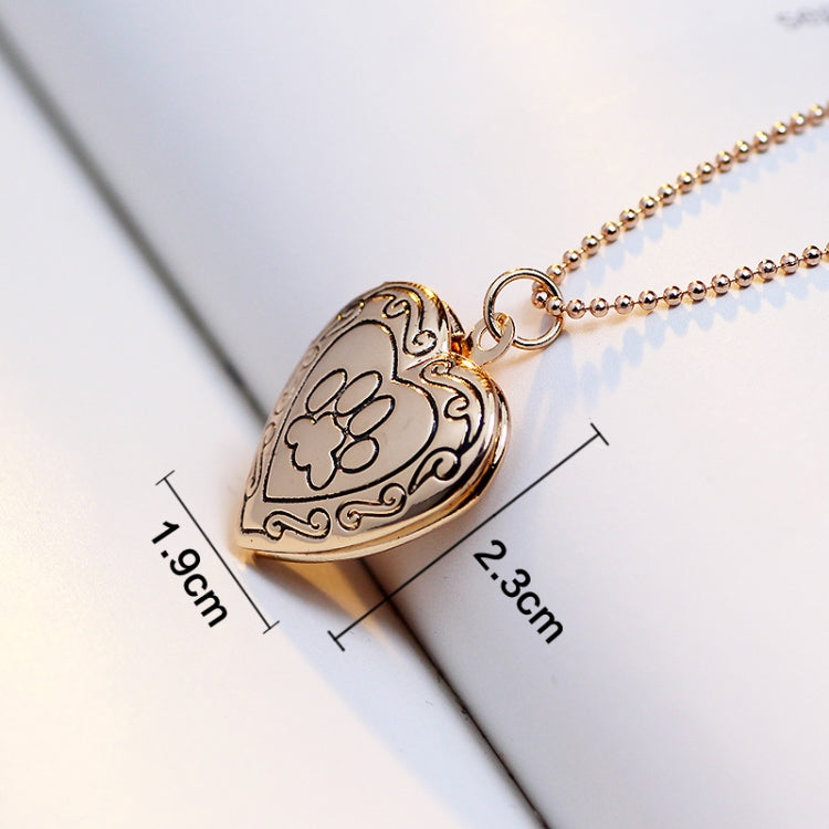 Gold-tone heart locket pendant necklace with paw-print front; ~1.1cm x 2.3cm