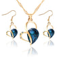 Gold-tone heart crystal pendant necklace set with matching drop earrings, blue faceted stone
