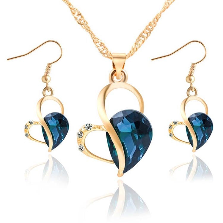 Gold-tone heart crystal pendant necklace set with matching drop earrings, blue faceted stone
