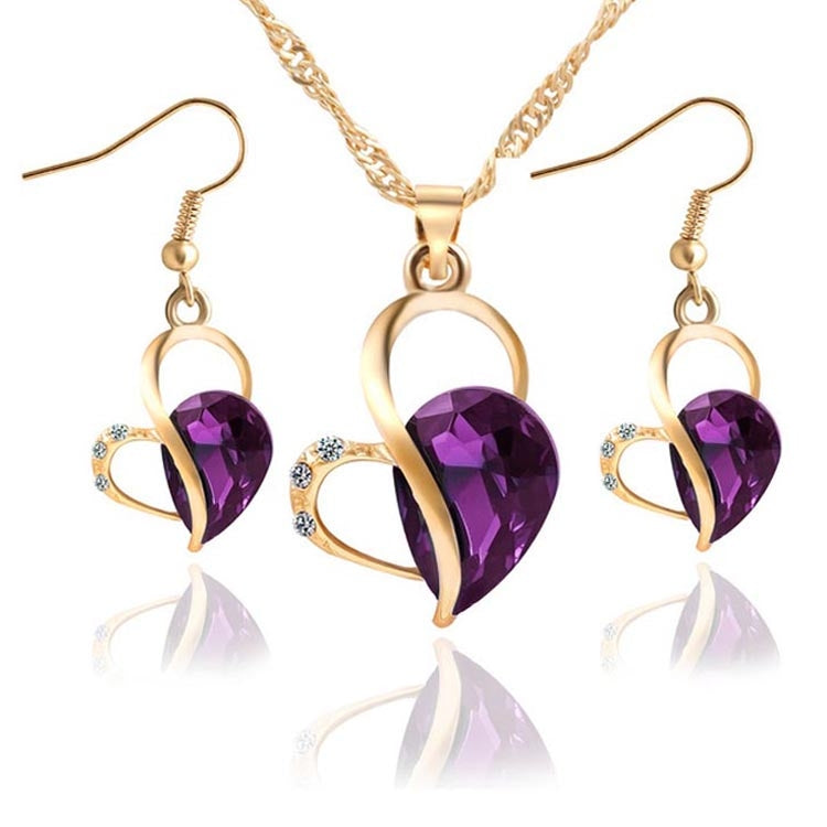 Gold-tone heart crystal pendant necklace set with matching drop earrings, purple faceted stone