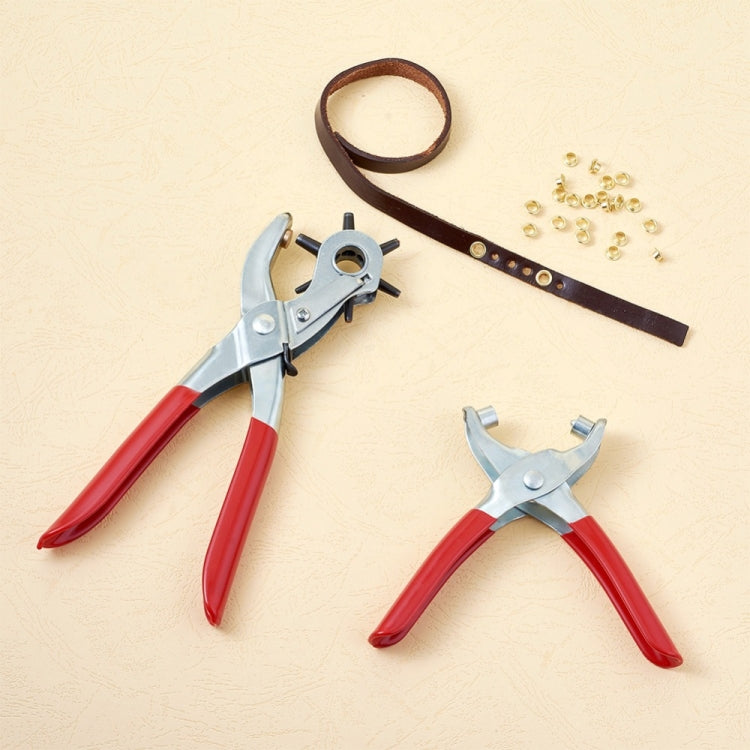 Steel eyelet punch pliers set with red handles, leather strap, and brass grommets