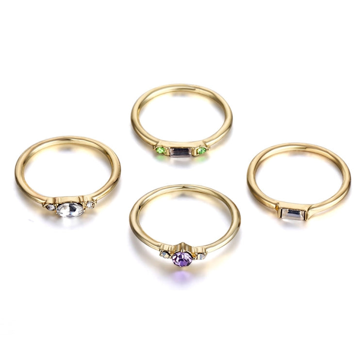Gold-tone 4-ring set featuring a green band, purple oval stone, clear center stone rings